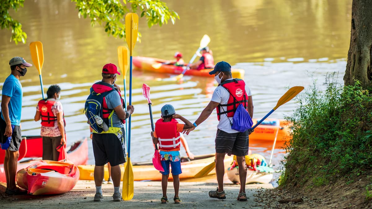 A group of kayakers launching at the Cape Fear River Adventures ramp in Lillington, NC